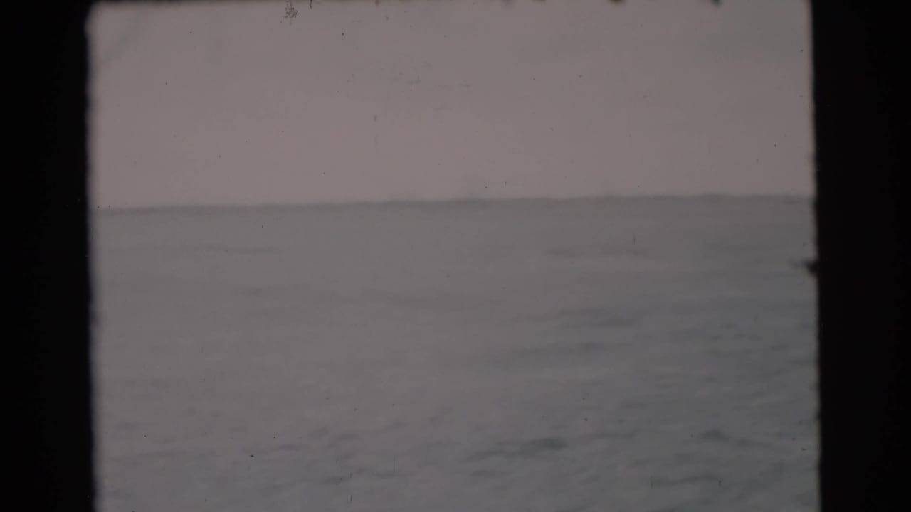 Open water and low horizon seen through an 8mm film frame.