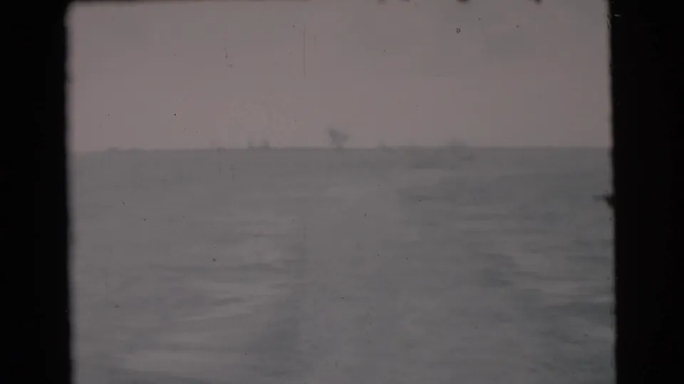 1956 Miami-area boat view looking over disturbed water or wake toward a faint horizon and pale sky.