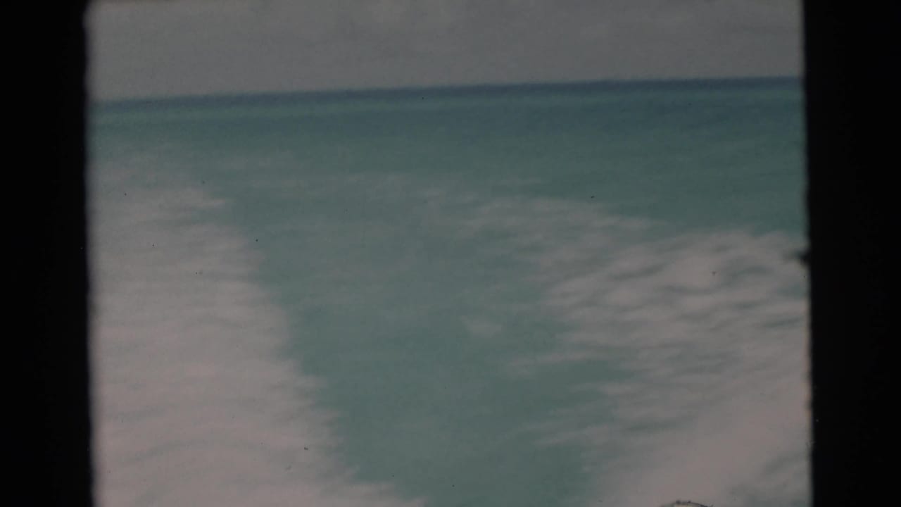 1956 8mm Florida boat footage showing open turquoise water, a low horizon, and soft overcast sky from an onboard viewpoint.