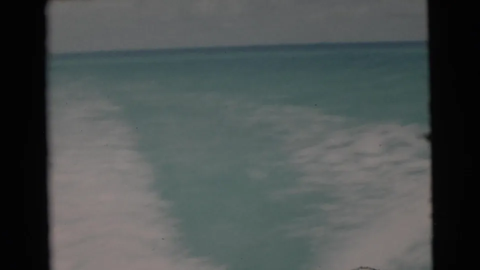 1956 8mm Florida boat footage showing open turquoise water, a low horizon, and soft overcast sky from an onboard viewpoint.