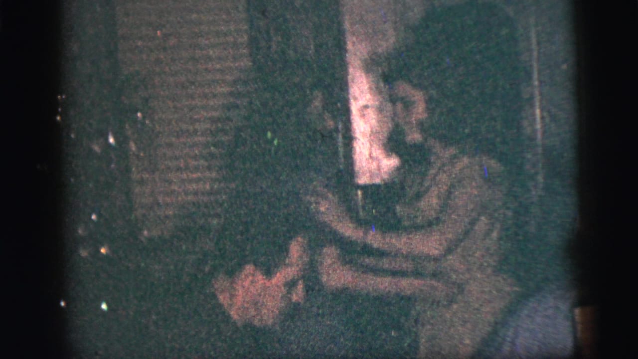 Two women dance together in a dark indoor party scene.