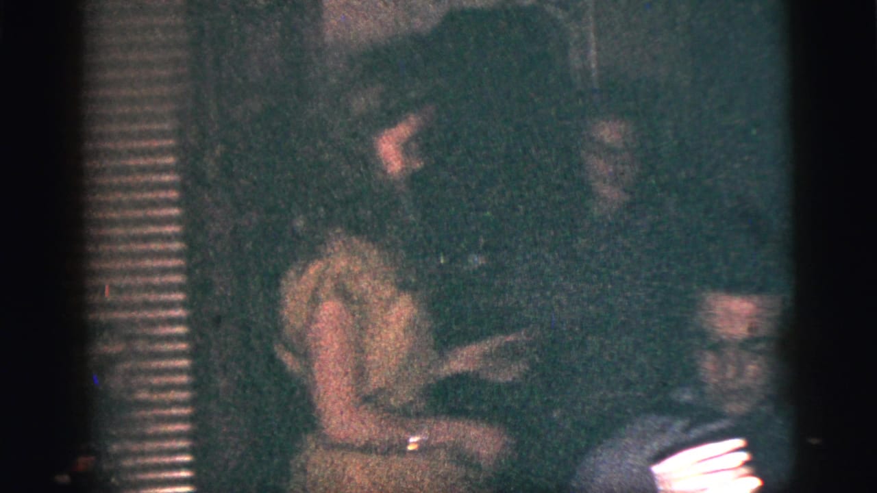 A young woman appears to dance near a seated accordion player during a 1956 New York City indoor gathering.