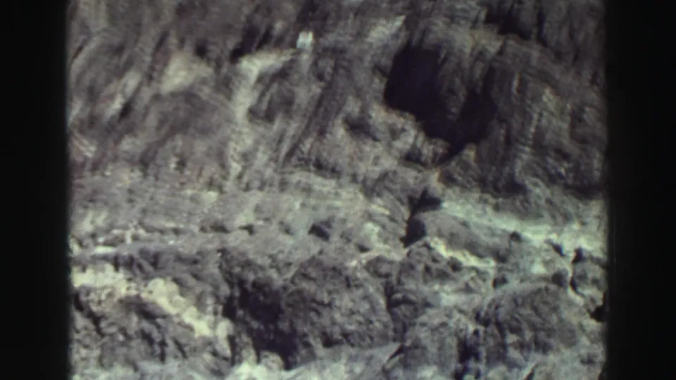 Rock face and gravelly lakeside ground in a faded 1969 Lake Tahoe home-movie frame.