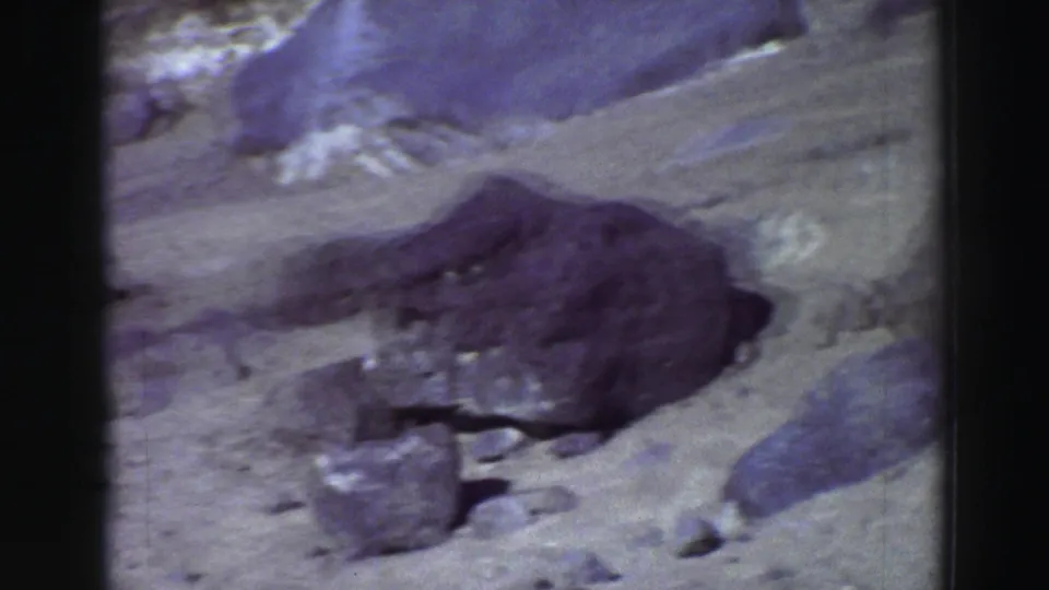The final frame shows boulders and dry rocky terrain, with no clear vehicle detail visible in this cropped section of the pan.