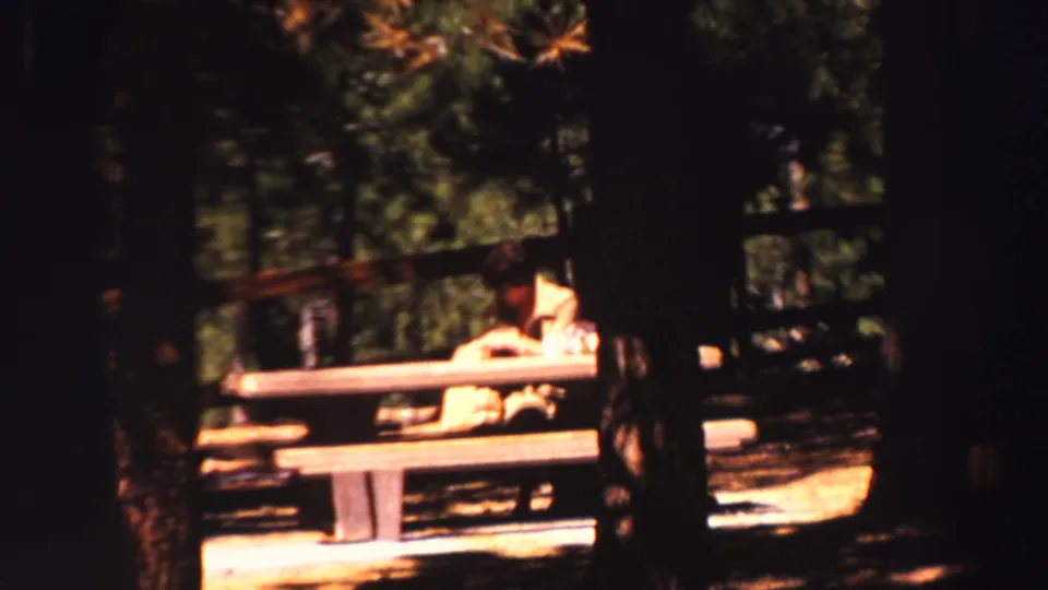 The final frame shows a quiet outdoor rest scene with one person at a picnic table among trees, likely from the Lake Tahoe travel reel.