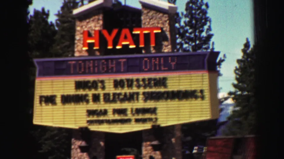 Close 1969 8mm view of the Hyatt sign at Lake Tahoe, including marquee text for the Sugar Pine Lounge and nightly entertainment.