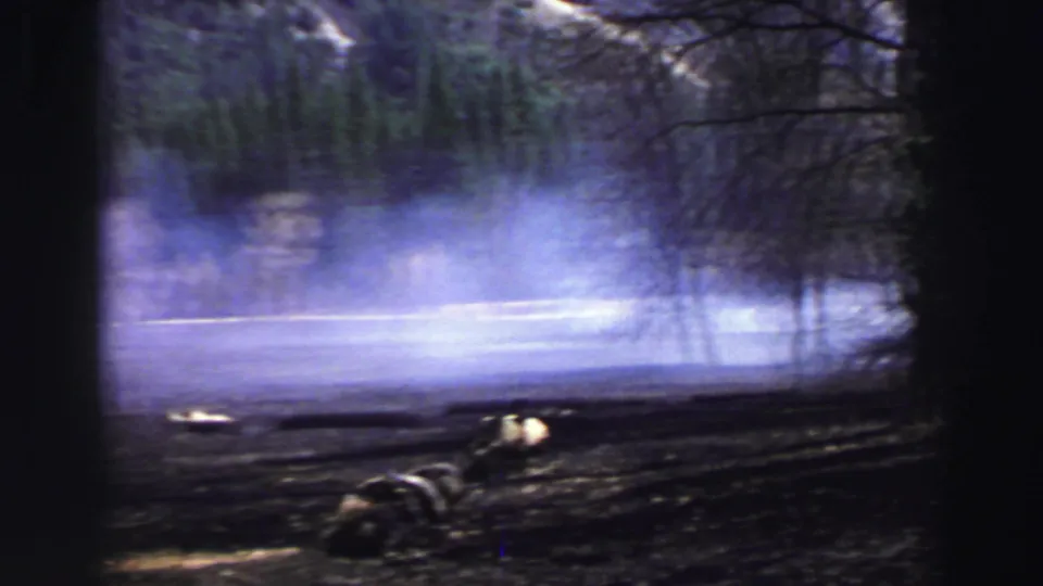 Mist lifts over a river or lake edge near trees in this 1969 Lake Tahoe 8mm home-movie frame.