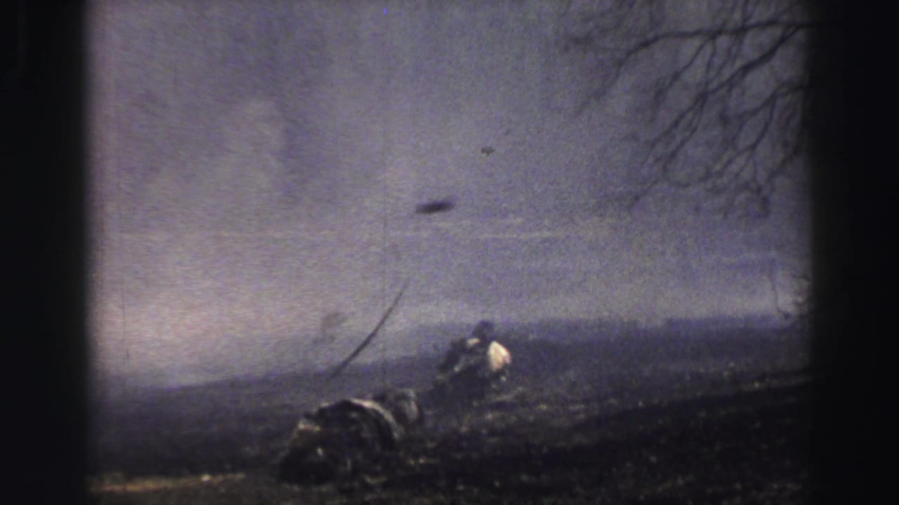 Severe wind near Lake Tahoe in 1969 appears to push haze across a dark field with bare trees and a small distant person or object.