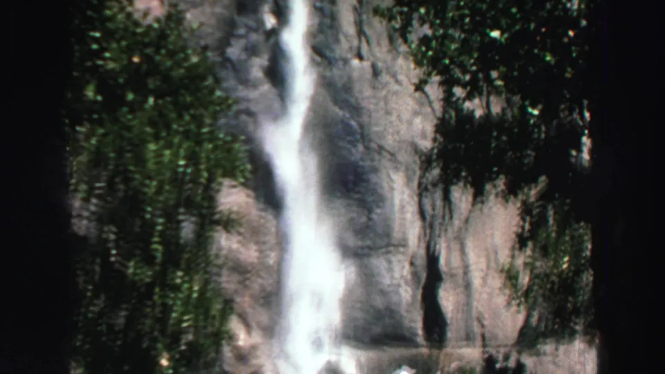 Lake Tahoe waterfall footage from 1969 showing falling water, dark rock, and trees in a soft 8mm frame.