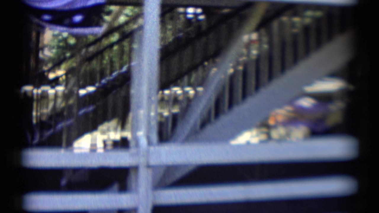 Blurred close view of railings and shaded structure from the riverboat area.