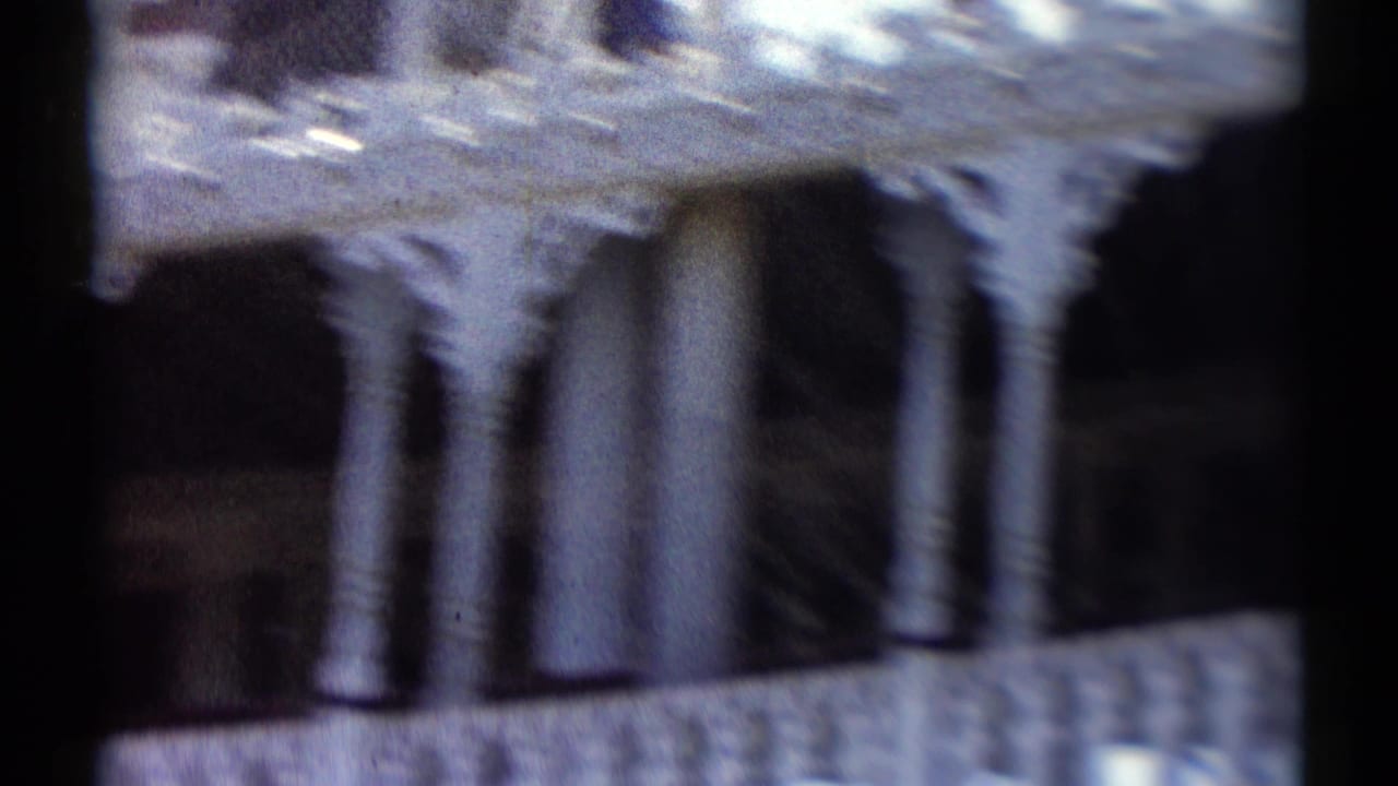 Soft close view of a white boat structure with columns and decorative railing.