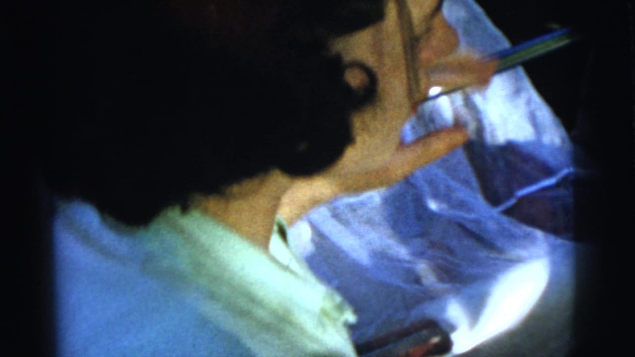 Close side view of a woman eating with a utensil in bright outdoor light.