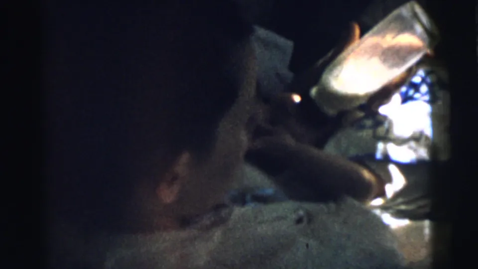 End frame of the 1961 Gary, Indiana home movie with the infant in soft focus and the bottle catching the brightest light.