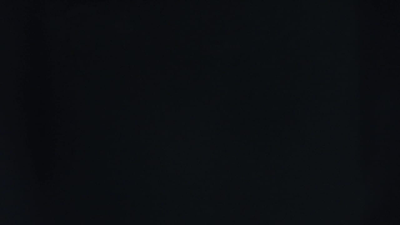 Nearly black frame with two small yellow lights near the upper edge.