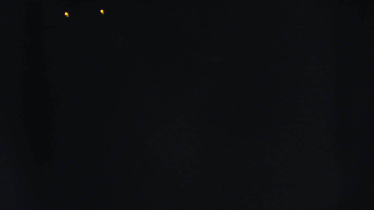 Dark frame with two small yellow lights close to the top edge.