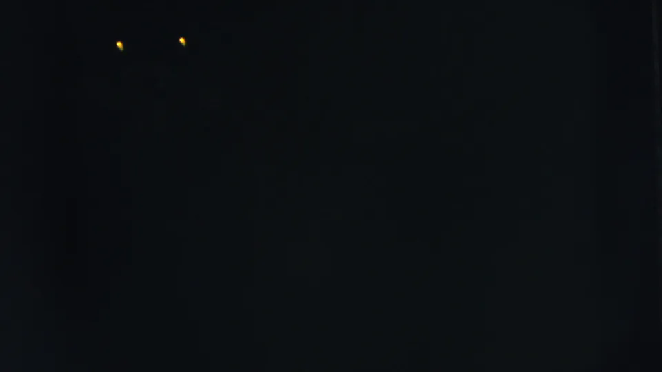1962 Moline, Illinois night footage with two distant yellow lights in the upper-left area of the frame.