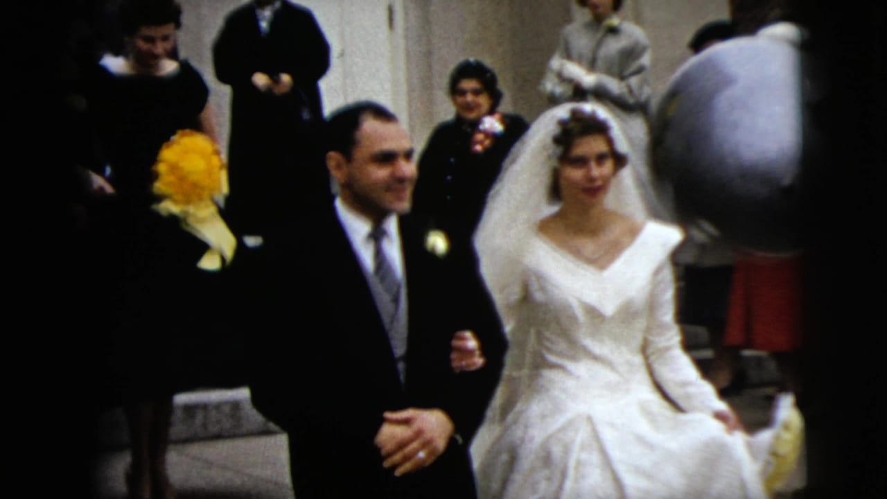 The bride and groom continue from the church entrance in Moline, Illinois, with guests in formal clothing visible on the steps behind them.