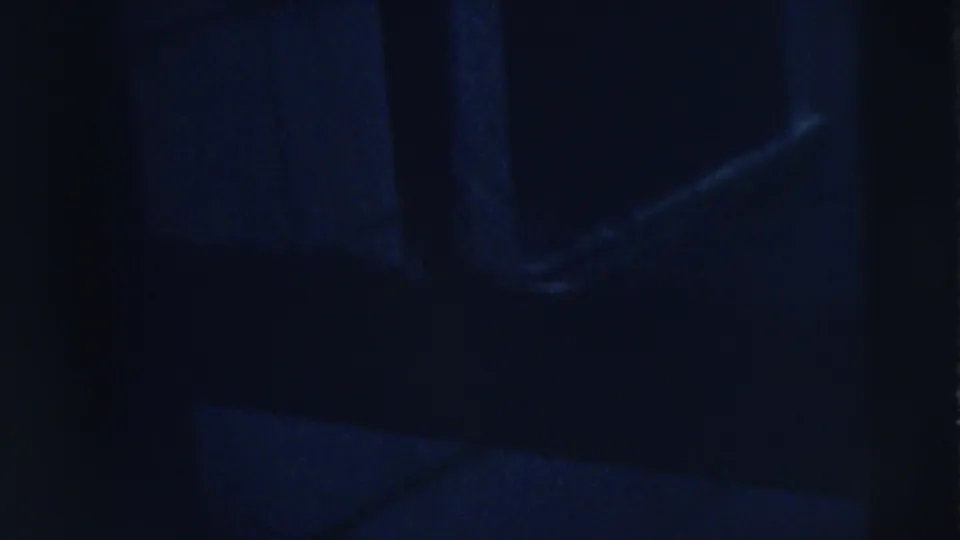 Opening 8mm frame from the Moline wedding clip shows a very dark doorway or interior area before the couple emerges.