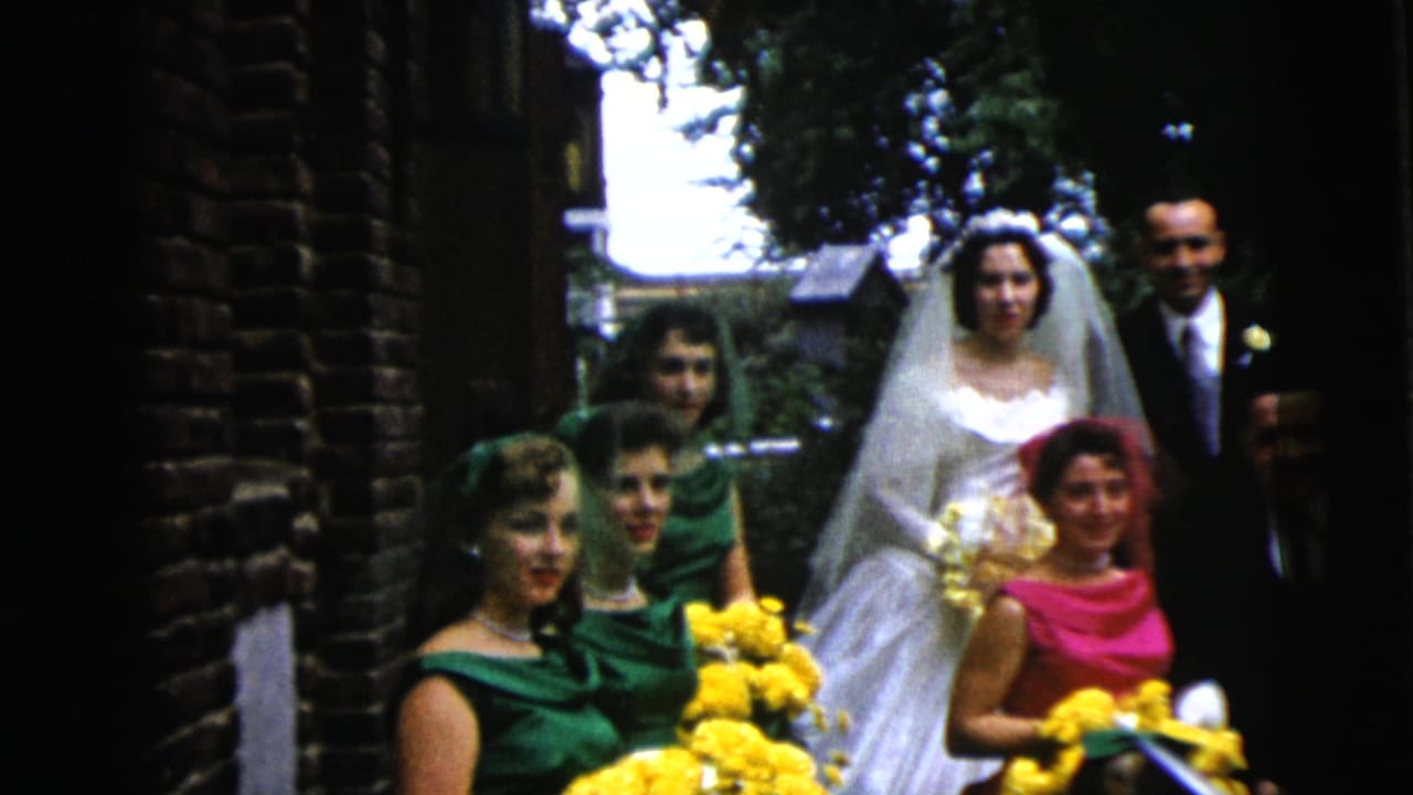 The 1962 Moline wedding group remains outdoors, with the bride and groom behind attendants holding bright yellow bouquets.
