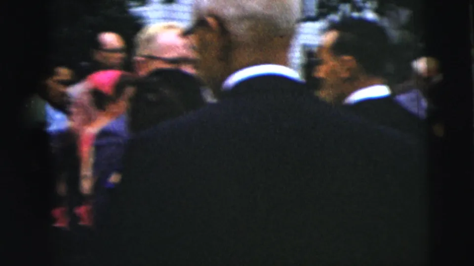 Suited men are seen from behind among guests outside a church-event crowd in Moline, Illinois, circa 1962.