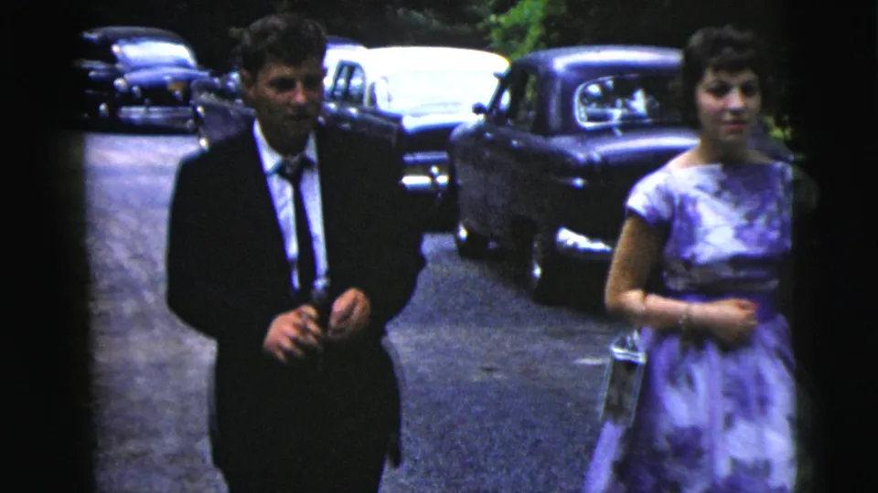 Near the end of the clip, the formally dressed couple passes close to the camera on a car-lined road in Moline, Illinois.