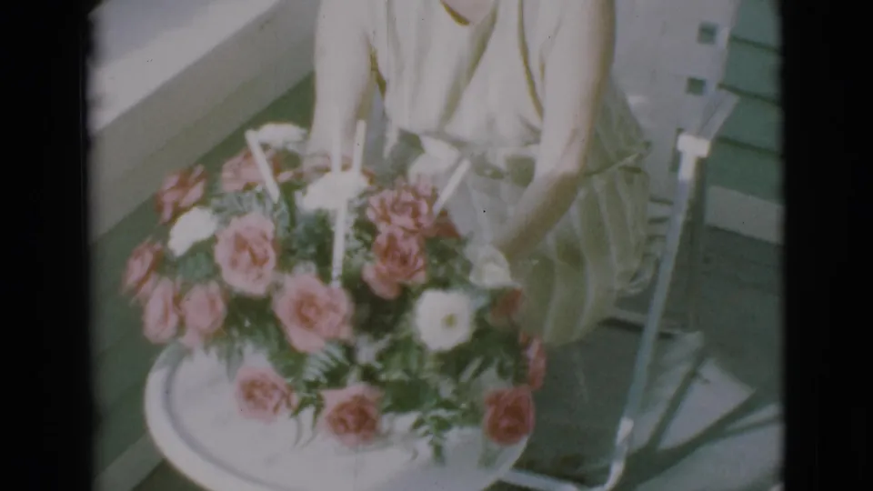 The bouquet fills the foreground as the seated woman holds or presents it in 1966 home-movie footage from Clarkdale, Arizona.