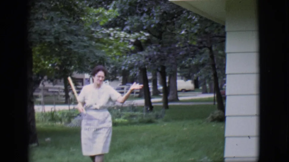 In the final 1966 Clarkdale frame, the woman raises both hands playfully while holding a rake on the lawn.