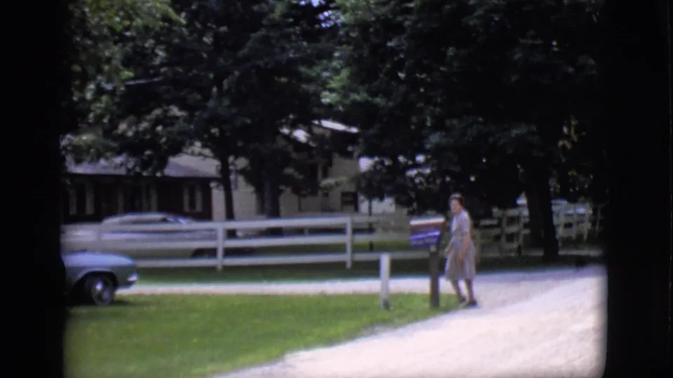 Near the end of the 1966 Clarkdale shot, the woman stands by the mailbox as part of a parked car appears near the house.