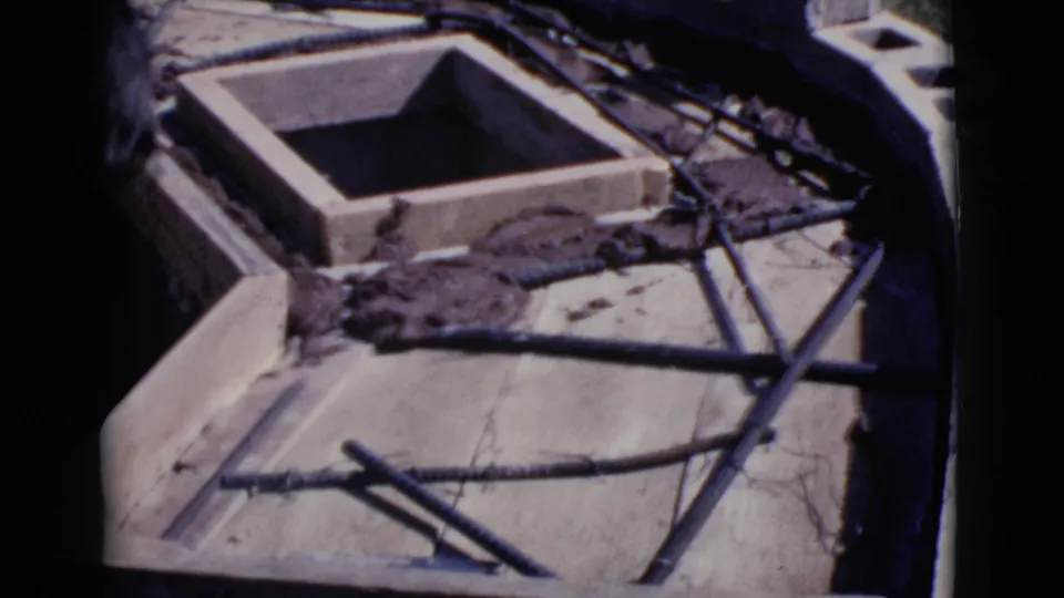 A square wooden construction form remains in view over rebar and wet grout, with tools nearby in the 1968 Cottonwood yard scene.