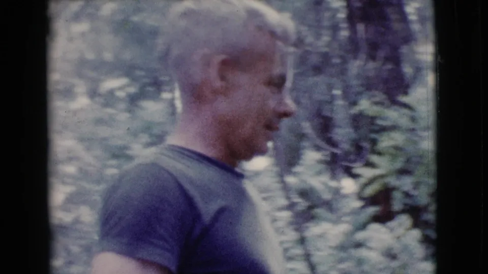 Side profile of the adult man in 1968 home-movie footage as he walks through trees and undergrowth near Cottonwood, Arizona.