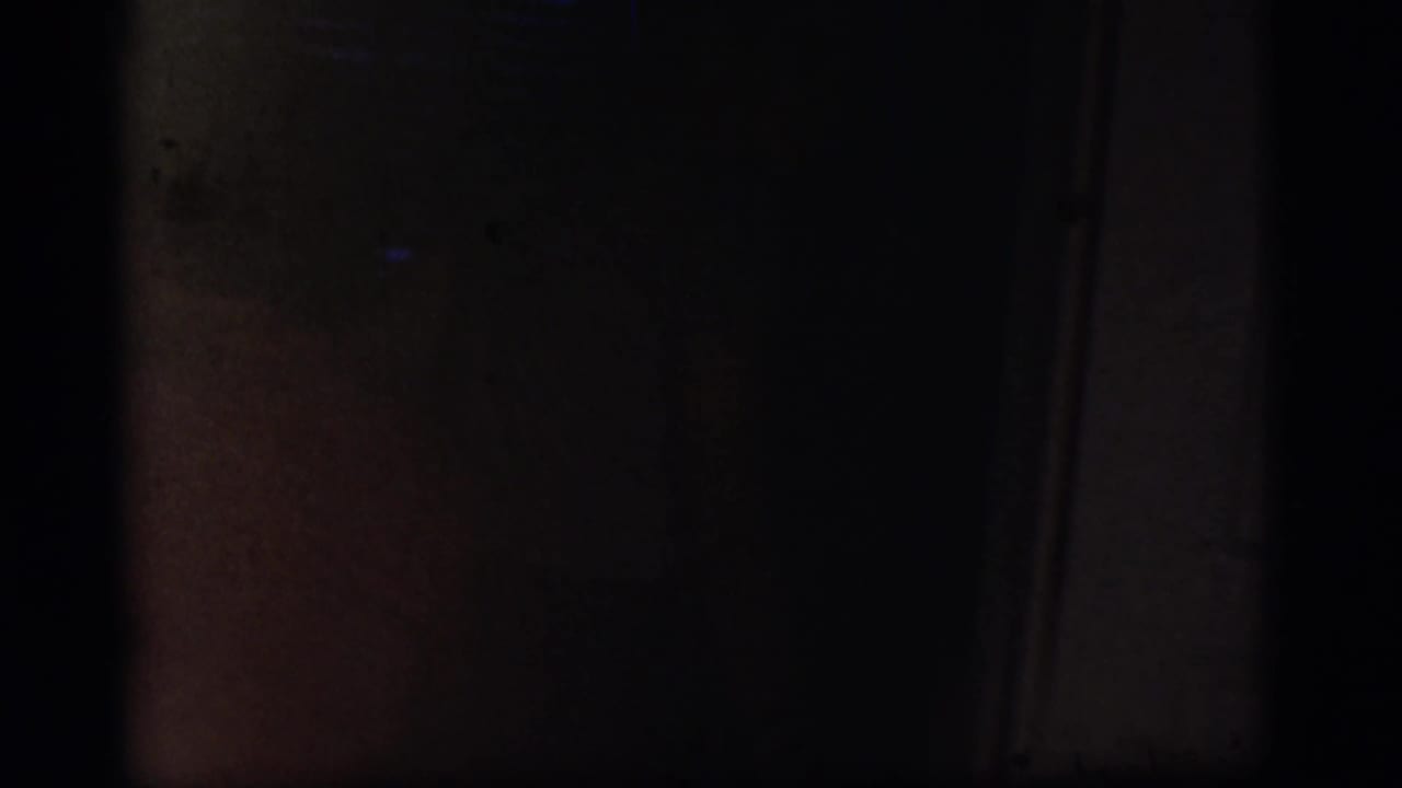 Dark transitional frame with little visible detail from the kitchen scene.