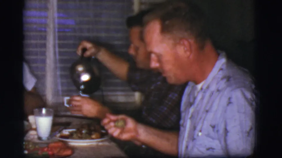 1968 Cottonwood, Arizona home interior showing one adult pouring coffee while another eats at the family dinner table.