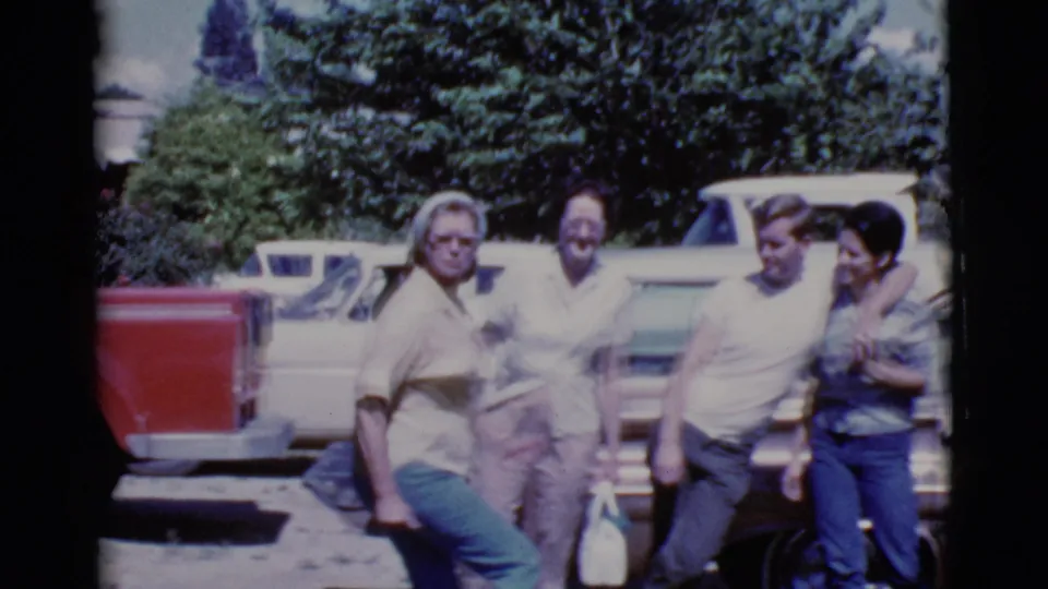 Four adults stand together near mid-century American cars in 1968 Cottonwood, Arizona home-movie footage.