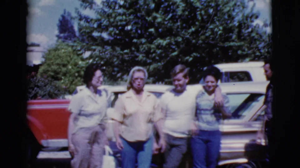 Near the end of the 1968 Cottonwood clip, the group starts to move beside the brown car as one person remains partly cropped at the edge.