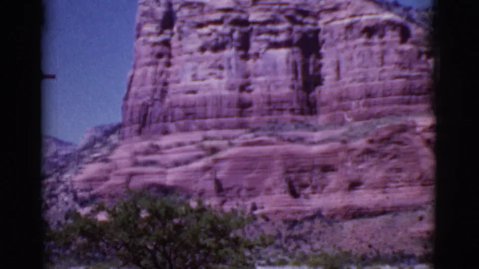 Final frame of the 1968 Cottonwood, Arizona pan, showing red sandstone formations above green desert shrubs and a narrow sky opening.
