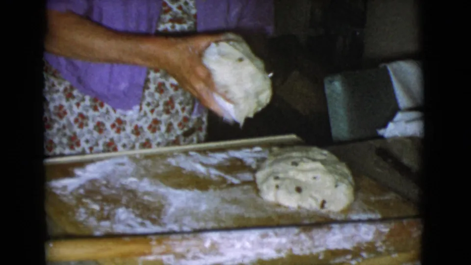 The final frame shows the woman lifting dough over a floured wooden surface, with another shaped loaf resting nearby in the 1968 kitchen.