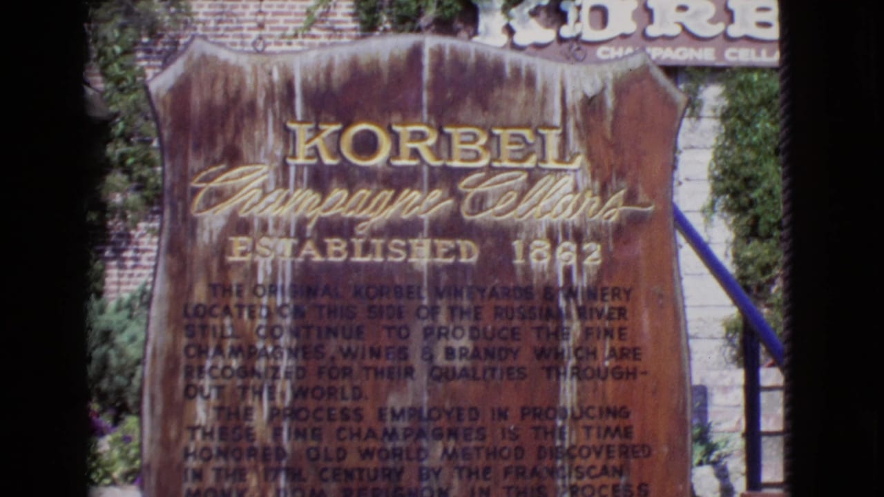 1968 San Diego County 8mm frame showing a weathered Korbel Champagne Cellars sign with established date and descriptive text.