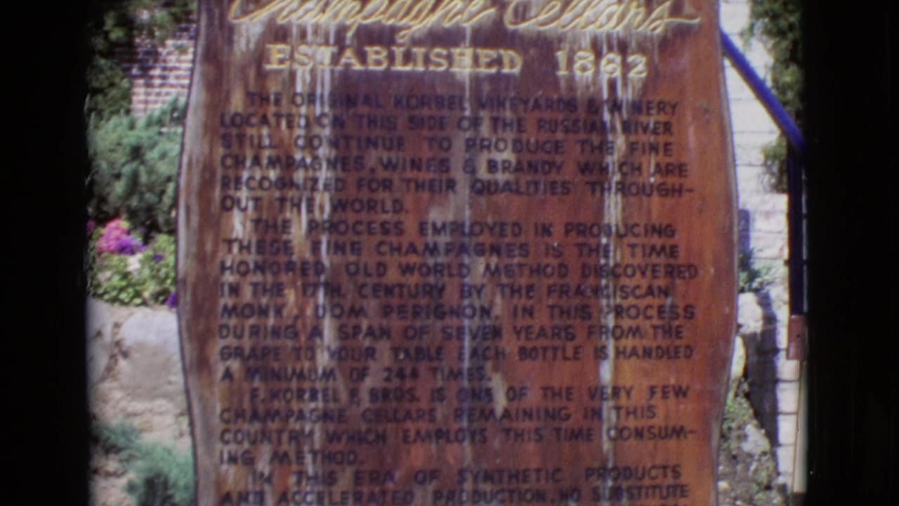 Close view of a weathered engraved winery monument with dark film borders.