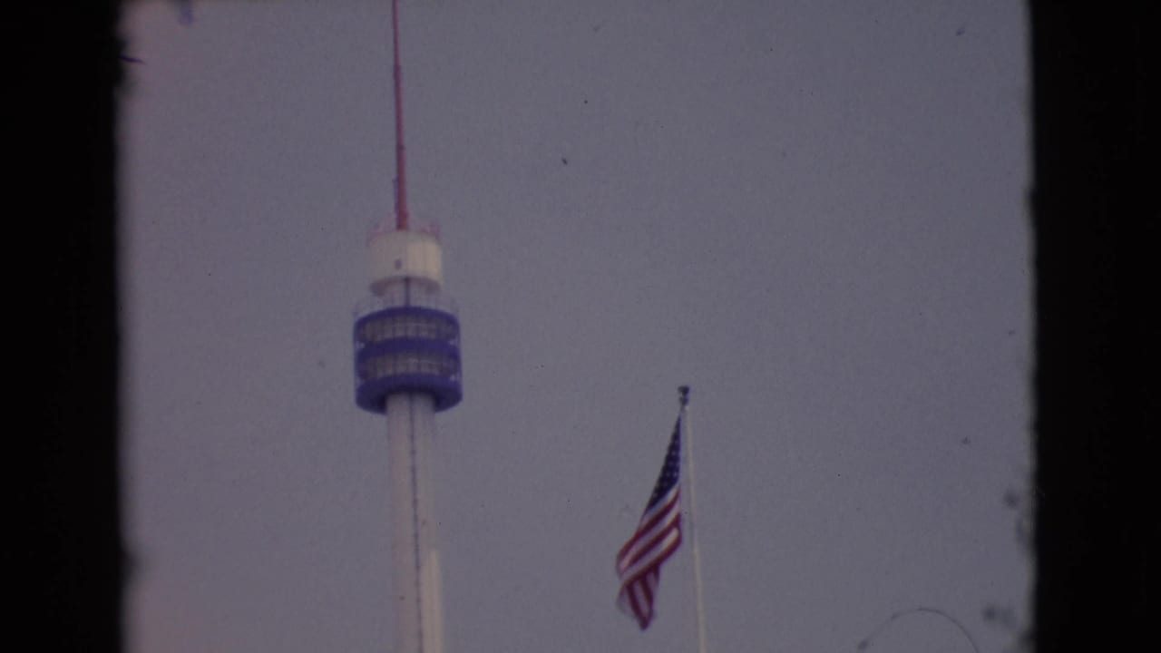 U.S. flag and tower seen through dark 8mm film borders.