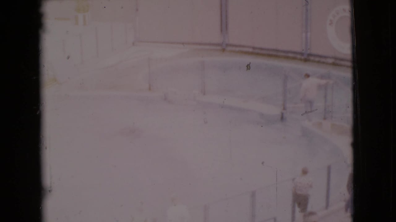 Overexposed glass panels and dark film borders during an upward pan.