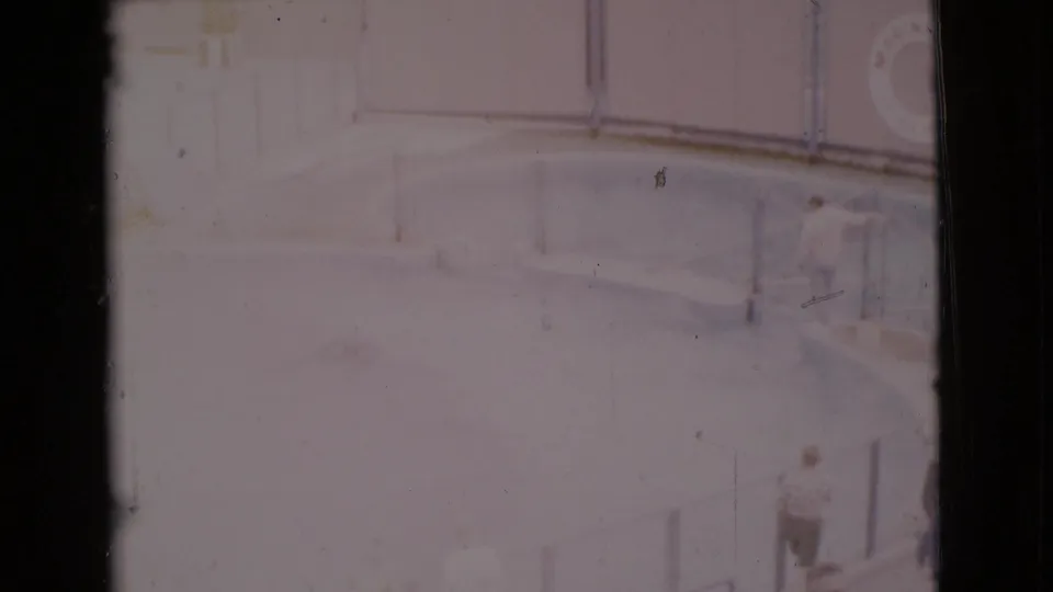 1968 San Diego County 8mm frame with pale glass ceiling detail, soft exposure, scratches, and dark film edges.