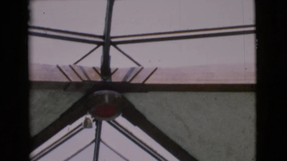 Handheld 8mm frame from San Diego County showing part of the glass ceiling and metal framing during the upward pan.