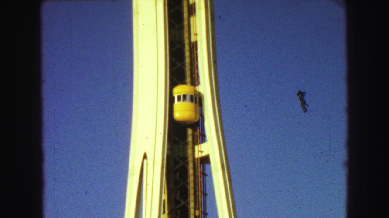 Yellow elevator near the upper section of a white tower structure.