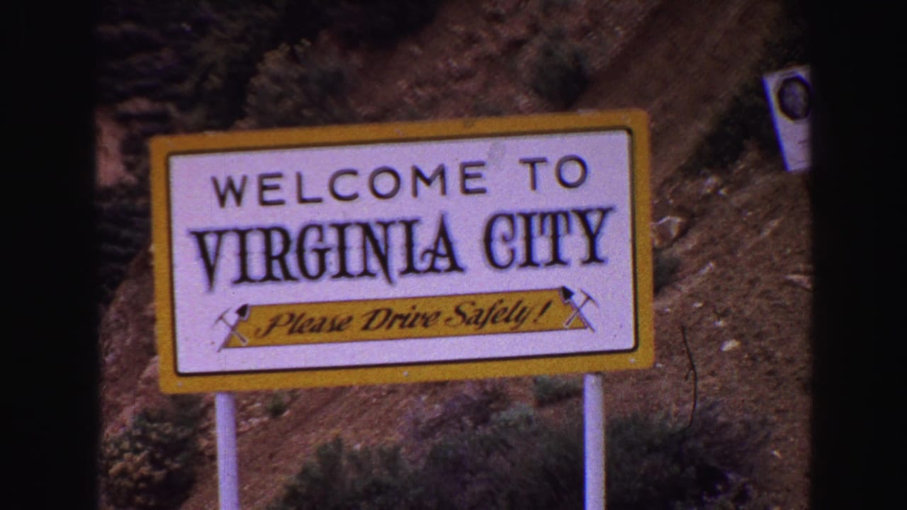 Welcome to Virginia City sign framed close against a rocky dirt hillside.