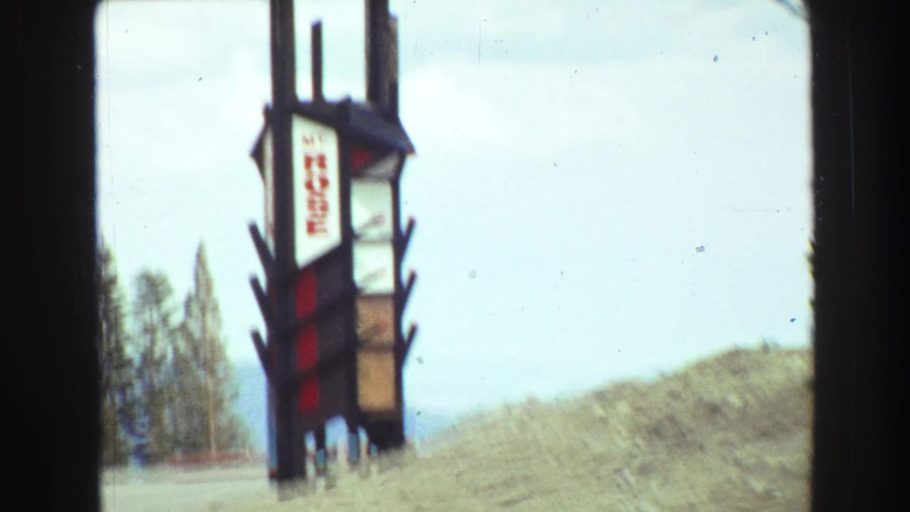 Closer windshield view of the Mt Rose sign along a snowy roadside.