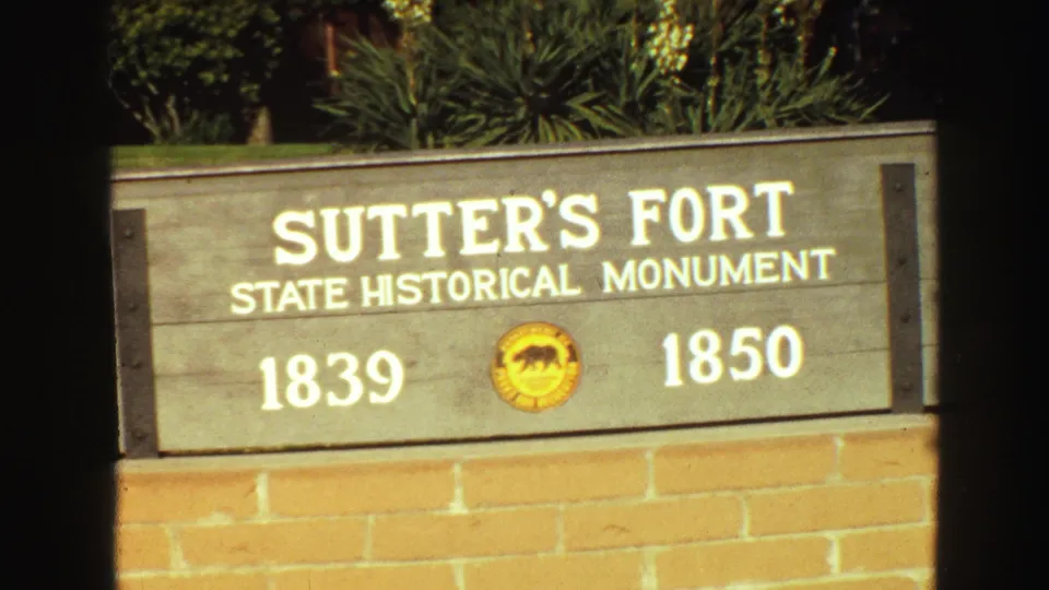 Close 1968 home-movie view of the Sutter's Fort State Historical Monument sign, including the dates 1839 and 1850.