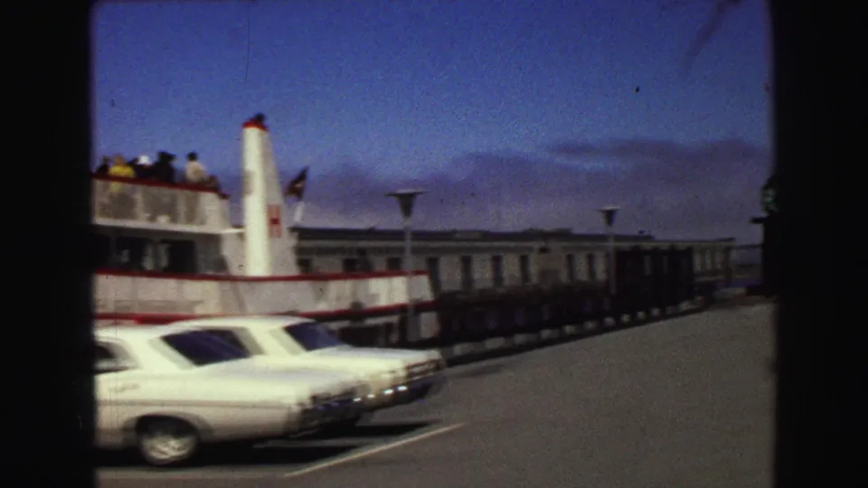 1968 Vancouver waterfront view with the ferry partly visible, sedans parked near the pier, and a long low pier structure.