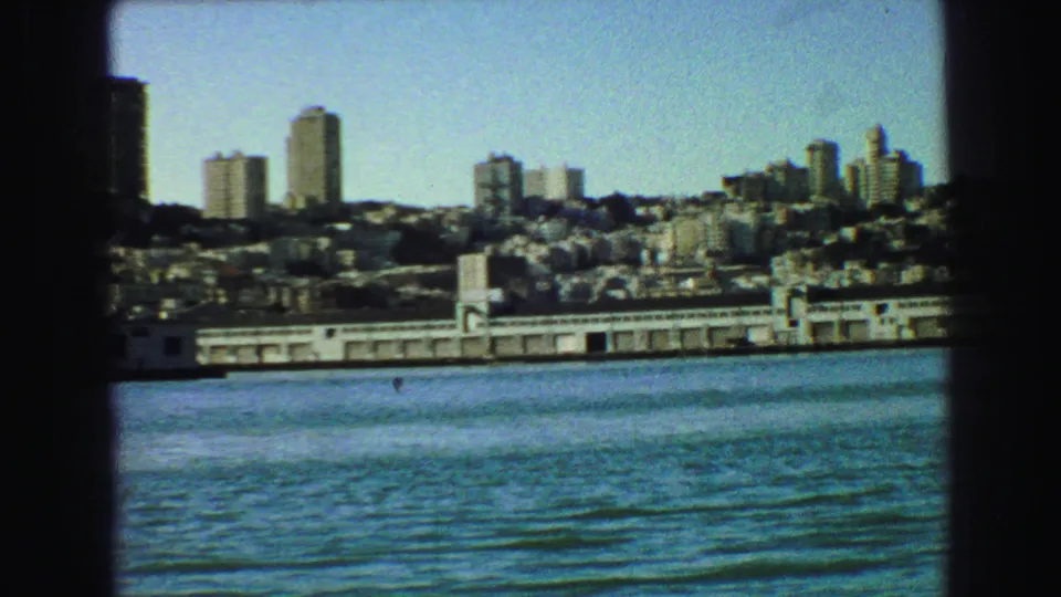 1968 Vancouver hillside skyline and low waterfront buildings viewed from across the water.