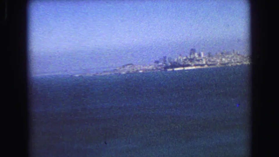 End of the 1968 Vancouver pan, with the waterfront skyline small on the horizon above dark blue water.