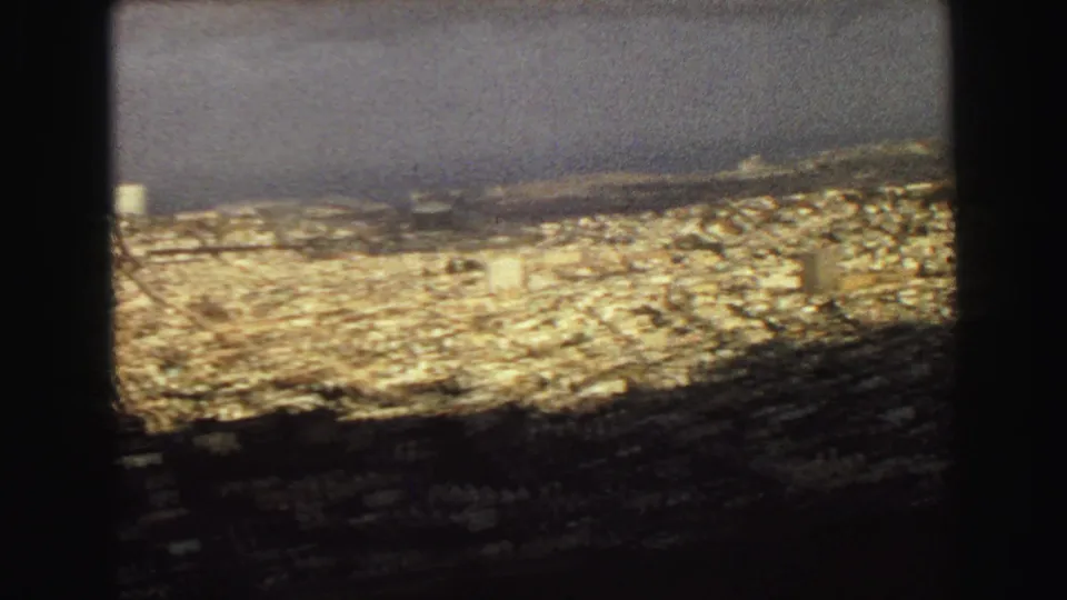 Late-1960s Vancouver city view from above, with tightly packed buildings leading toward the waterfront.